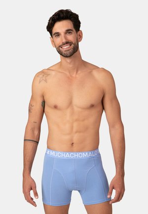 Light blue cotton boxer briefs with a white logo waistband, featuring a form-fitting design and a smooth texture.