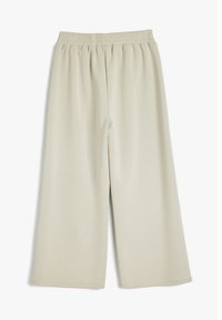 Lichtbeige wijde broek gemaakt van zachte stof, met een elastische tailleband en een glad, gemêleerd oppervlak.