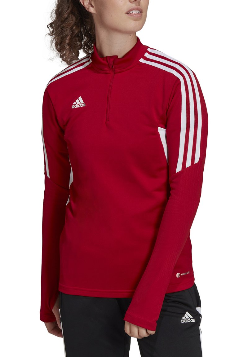 Rood sportief langmouwtop met een halve rits, witte zijstrepen en ribbelstructuur. Voorzien van het Adidas-logo op de borst en onderrand.