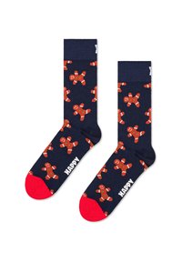Chaussettes bleu marine ornées d'un motif de bonhommes en pain d'épice avec des talons et des bouts rouges. Le mot "HAPPY" est imprimé en blanc sur une chaussette.