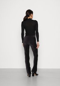 Calvin Klein Jeans VELVET SKINNY PANTS - Calças - black