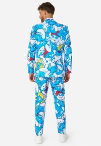 Colorful suit featuring a blue, white, and red pattern of cartoon characters, made of fabric with a smooth texture and fitted design.