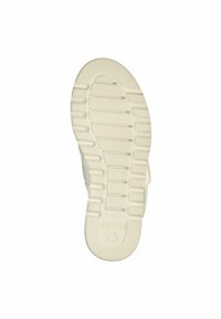 White shoe sole featuring deep grooves and ridges for traction. Textured surfaces with a circular emblem near the heel and size marking.