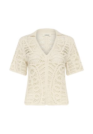 Top en crochet crème avec un col en V, des manches courtes et un design en ajour complexe avec un motif texturé sur l'ensemble.