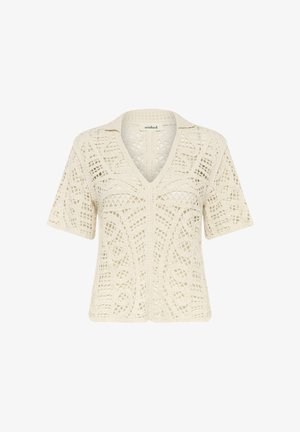 Top de crochet crema con escote en V, mangas cortas y un intrincado diseño de calado con un patrón texturizado en toda la prenda.