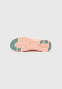 Shoe sole in pale pink with textured ridges; features dark teal accents at heel and midfoot. Flat, athletic design suitable for casual wear.