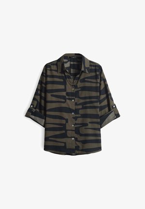 Camo-patterned shirt in dark green and black, featuring a buttoned front, collar, and rolled sleeves. Soft fabric with a smooth texture.