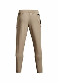 Beige sportbyxor i lätt material, med elastisk midja, sidofickor och smalnande ben med svarta detaljer.