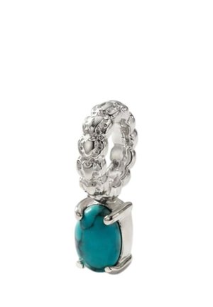 Silver ring with interlocking chain links and a dangling oval turquoise stone set in a silver clasp.