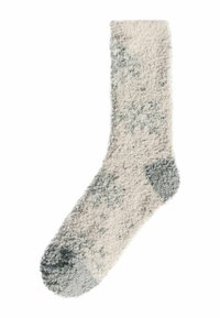 Calcetín de felpa en crema con manchas grises. Textura gruesa y suave con refuerzo en el talón y la punta. Diseño de altura de tobillo para mayor comodidad.