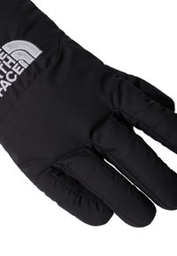 Črna izolirana rokavica z teksturirano tkanino, z izrazitim belim logotipom na zapestju. Petprstni dizajn, oblazinjeno za toploto.