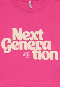 Pink cotton t-shirt featuring bold, white, playful text: "Next Generation" with "ONLY SINCE 1995" in a smaller font. Short sleeves, crew neck.