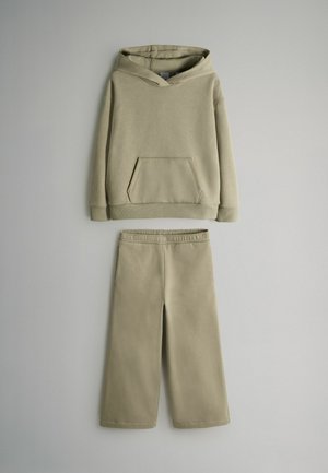 Khaki hoodie with a front pocket and adjustable drawstring, paired with matching wide-leg pants featuring an elastic waistband.