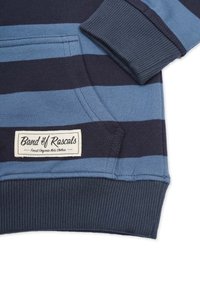 Blå och marinrandig sweatshirt med ribbade muddar, en framficka och en stickad logotagg på nedre vänstra sidan. Mjuk bomullstyg.