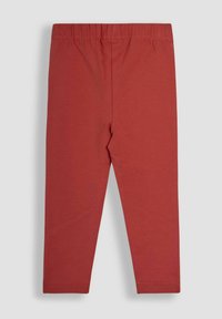 Leggings rossi in cotone con vita elasticizzata, caratterizzati da una superficie liscia e un design aderente, adatti per un abbigliamento casual.