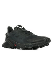 Black trail running shoe with a textured upper, featuring a quick-lace system, rugged outsole, and distinct red accents on the sole.