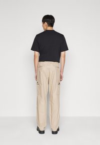 HUGO GARLO - Oldalzsebes nadrágok - medium beige