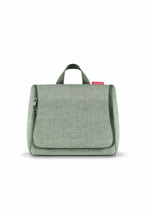 Green fabric toiletry bag with a zip closure, flat design, top handle, and front flap pocket. Features textured material and subtle stitching.