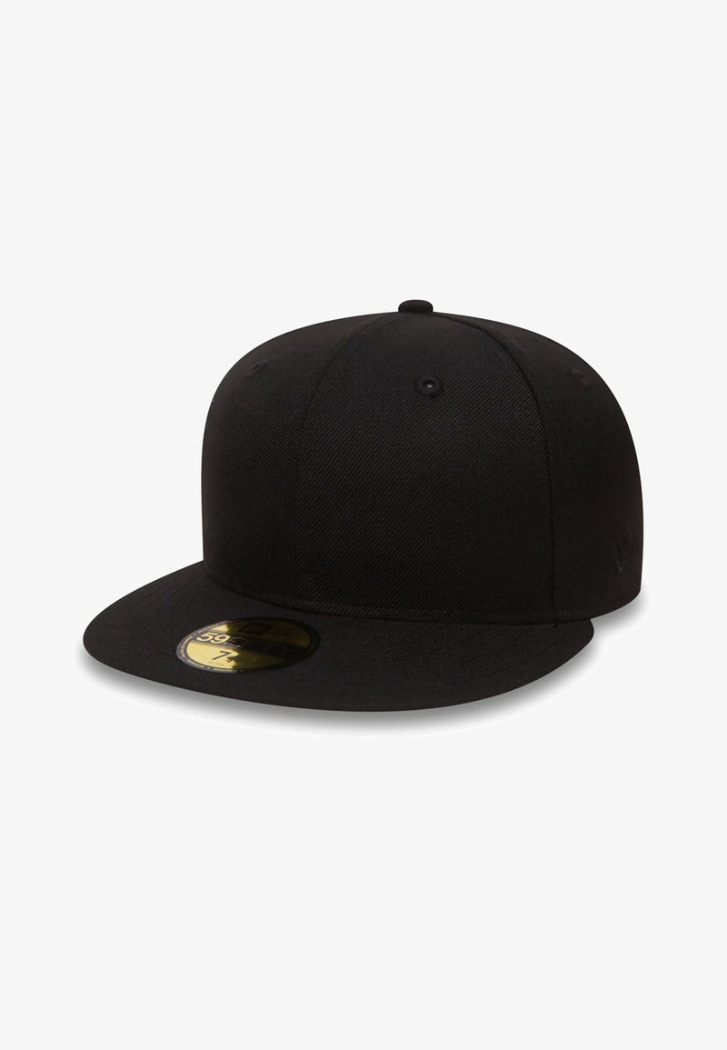 Black cap made of fabric with a flat brim. Features a textured surface, ventilation holes, and a round sticker on the brim.