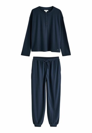 Dunkelblaues Henley-Oberteil mit langen Ärmeln und Knopfleiste sowie passende Jogginghose mit Kordelzug und elastischen Bündchen.
