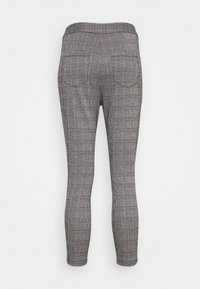 Grå rutiga leggings med hög midja och två bakfickor. Tyget har en mjuk textur med ett precis geometriskt mönster.