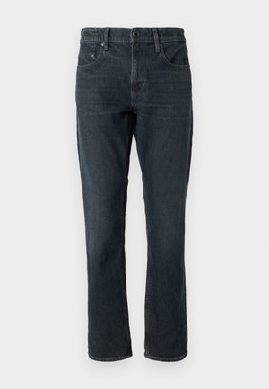 Mörkblå denimjeans med rak passform, femficksdesign och knäppning. Har subtila blekningar och kontrasterande sömmar.