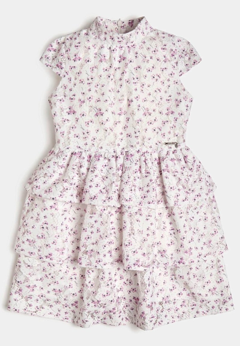 Robe blanche sans manches à volants avec un petit imprimé floral rose et violet, col montant avec fermeture par bouton dans le dos.