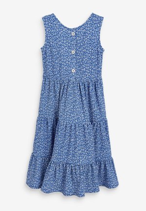 Robe bleue sans manches avec imprimé floral blanc, trois boutons sur le devant et ourlet à volants superposés.