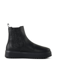 Bottines en cuir noir avec des panneaux en tissu texturé, un bout arrondi et une semelle en caoutchouc épaisse présentant un motif de relief décoratif.