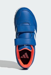 Blue athletic shoe with two Velcro straps, white stripes, and an orange inner lining. Textured upper with a padded tongue and a rubber sole.
