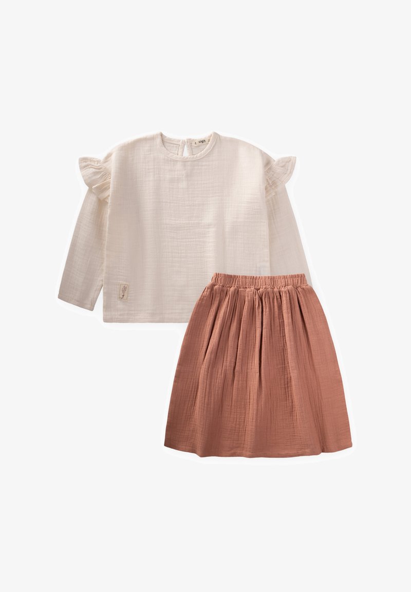 Two-piece outfit featuring a cream, long-sleeve top with ruffle sleeves and a pink, gathered skirt. Made from textured fabric.