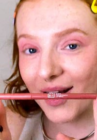 Automatic lip pencil in soft pink shade. Long cylindrical shape with a twist mechanism, featuring branding and a smooth matte finish.