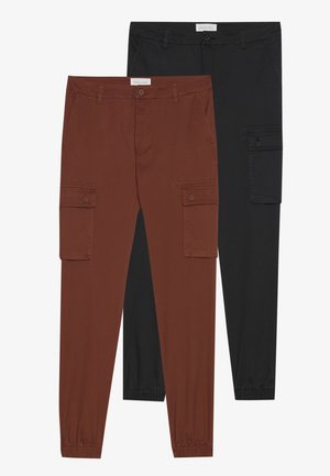 Cargo pants in brown and black. Features include side pockets, elasticized cuffs, and a smooth texture. Fabric appears lightweight and durable.