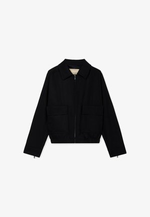 Black cropped jacket with a front zipper, wide collar, two large front flap pockets, and long sleeves with zipper cuffs.