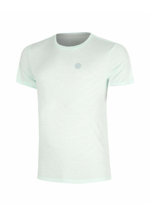 Camiseta lisa de color verde claro, de manga corta y cuello redondo, con un pequeño logo circular centrado en el pecho.