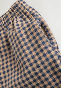 Rutig gingham-stof i beige og marineblå, med en blød tekstur, elastisk talje og detaljer med sidelukning.