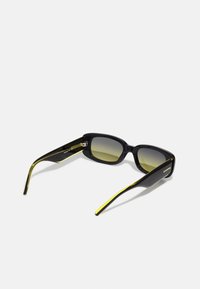 Black rectangular sunglasses with gradient green lenses. Features yellow accents on the temples and a sleek plastic frame.