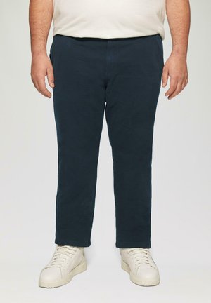 Marineblauwe katoenen broek met een rechte pasvorm, uitgerust met zijzakken en een soepele textuur, gecombineerd met witte hoge sneakers.