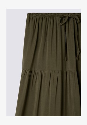 Oliwkowa, średniej długości spódnica z miękkiego materiału, z marszczonym, elastycznym pasem i wiązaniem z przodu. Rozkloszowany krój.