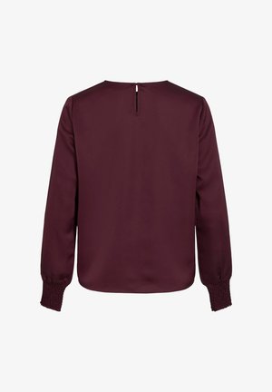 Bordo bluzica dugih rukava s otvaranjem na leđima, glatke teksture i nabranim rukavima, koja ima opušteni kroj i minimalistički dizajn.