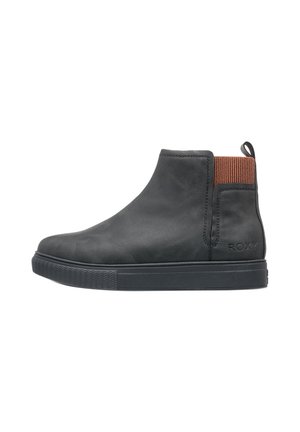 Black ankle boot with brown elastic side panel, pull tab at heel, flat rubber sole, and "ROXY" embossed on outer heel.