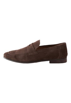 Mocassin homme en daim marron avec détails cousus et petit talon en bois, vu de profil sur fond blanc.