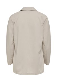 Béžová bunda s výrazným límcem, dlouhými rukávy a volným střihem. Látka vypadá hladká, bez viditelných vzorů nebo kovových doplňků.