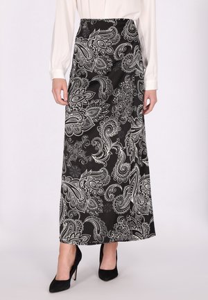 Falda maxi en negro con patrones de paisley blancos. Confeccionada en tela suave, cuenta con una cintura ajustada y llega hasta los tobillos.