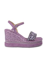 Sandalo con tacco viola con design intrecciato in giute, impreziosito da una fascia gioiello. Presenta una tomaia in suede testurizzato e una fibbia alla caviglia regolabile.