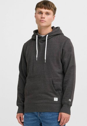 Sudadera gris oscuro con cordones, bolsillo frontal, puños y dobladillo de canalé. Presenta una etiqueta en el bolsillo y un logo en la manga. Textura suave.
