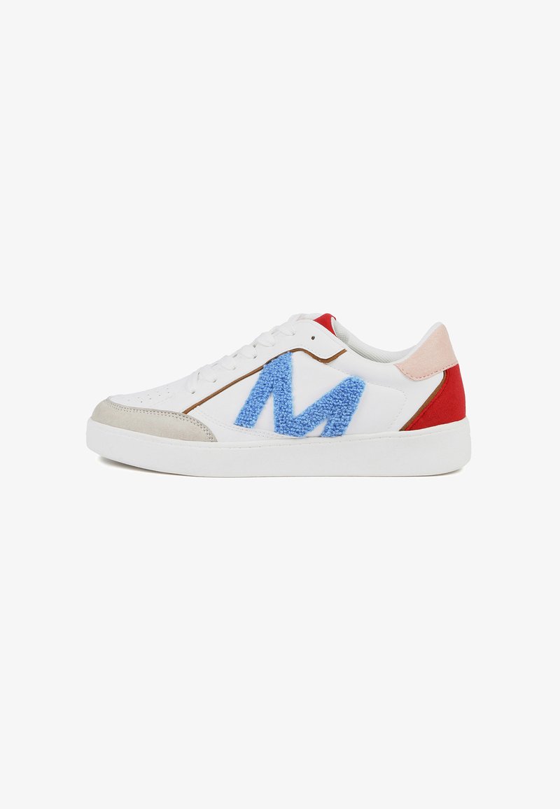 White sneakers with gray suede accents, blue fuzzy "M" logo, red heel, and light pink tongue. Smooth leather upper and rubber sole.