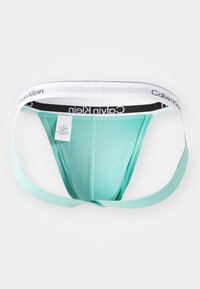 Perizoma in cotone verde menta con una sottile fascia in vita, caratterizzato dal logo Calvin Klein in bianco e nero. Texture liscia con cuciture minime, che offre una vestibilità aderente.