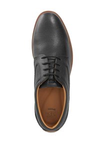 Black leather shoe with textured upper, round toe, and brown rubber sole. Features laces and an orange interior lining with branding visible.