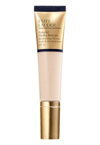 Tube Estee Lauder Futurist Hydra Rescue, couleur crème, avec un bouchon doré et bleu marine. Contient du maquillage hydratant et un SPF 45 pour la protection solaire.